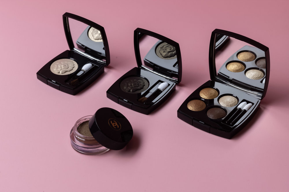 From left to right:     Ombre Première Longwear Powder Eyeshadow         in       Electrum Lame &amp; Noir Lame,         Les 4 Ombres Multi-Effect Quadra Eyeshadow     in Condes Elegents,     Ombre Première Longwear Cream Eyeshadow     in Silver Pink