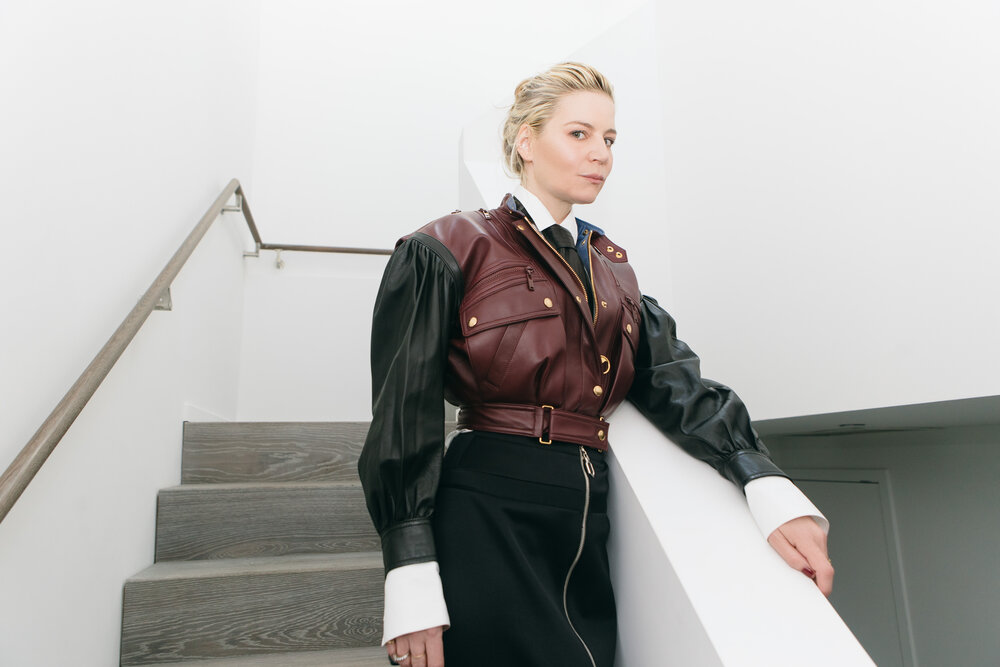Julia wears a Louis Vuitton leather jacket and skirt, white shirt by Alaïa, and a Sally LaPointe belt as a tie.